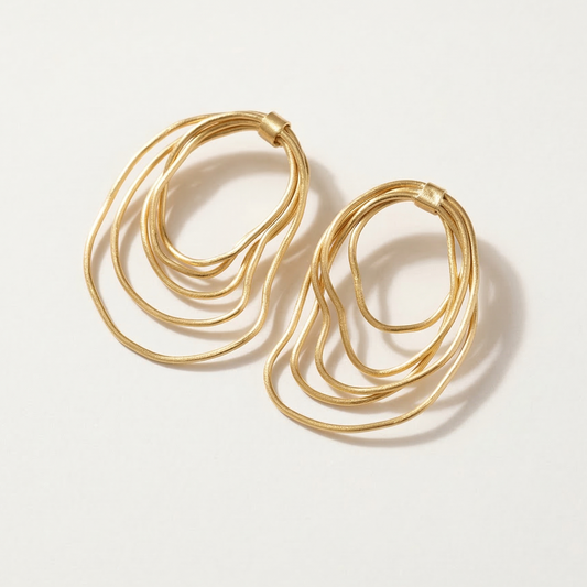 Gold hoop earrings on a light gray background