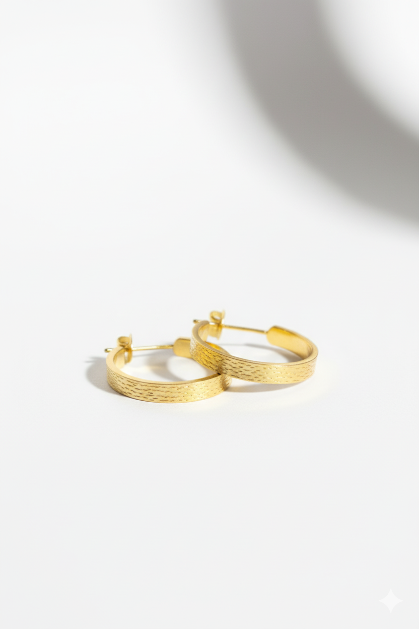 Gold hoop earrings on a white background