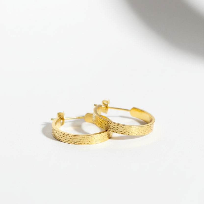 Gold hoop earrings on a white background