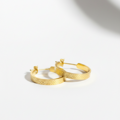 Gold hoop earrings on a white background