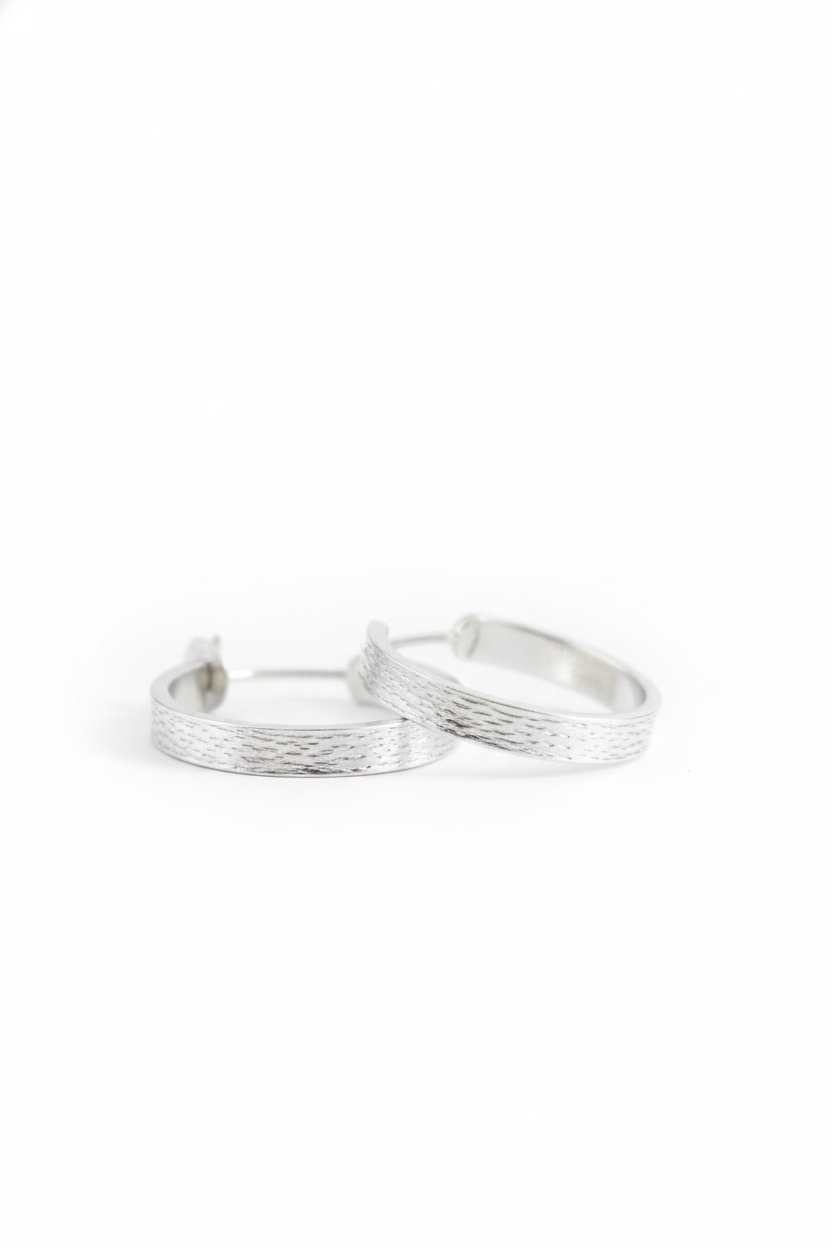 Pair of silver hoop earrings on a white background