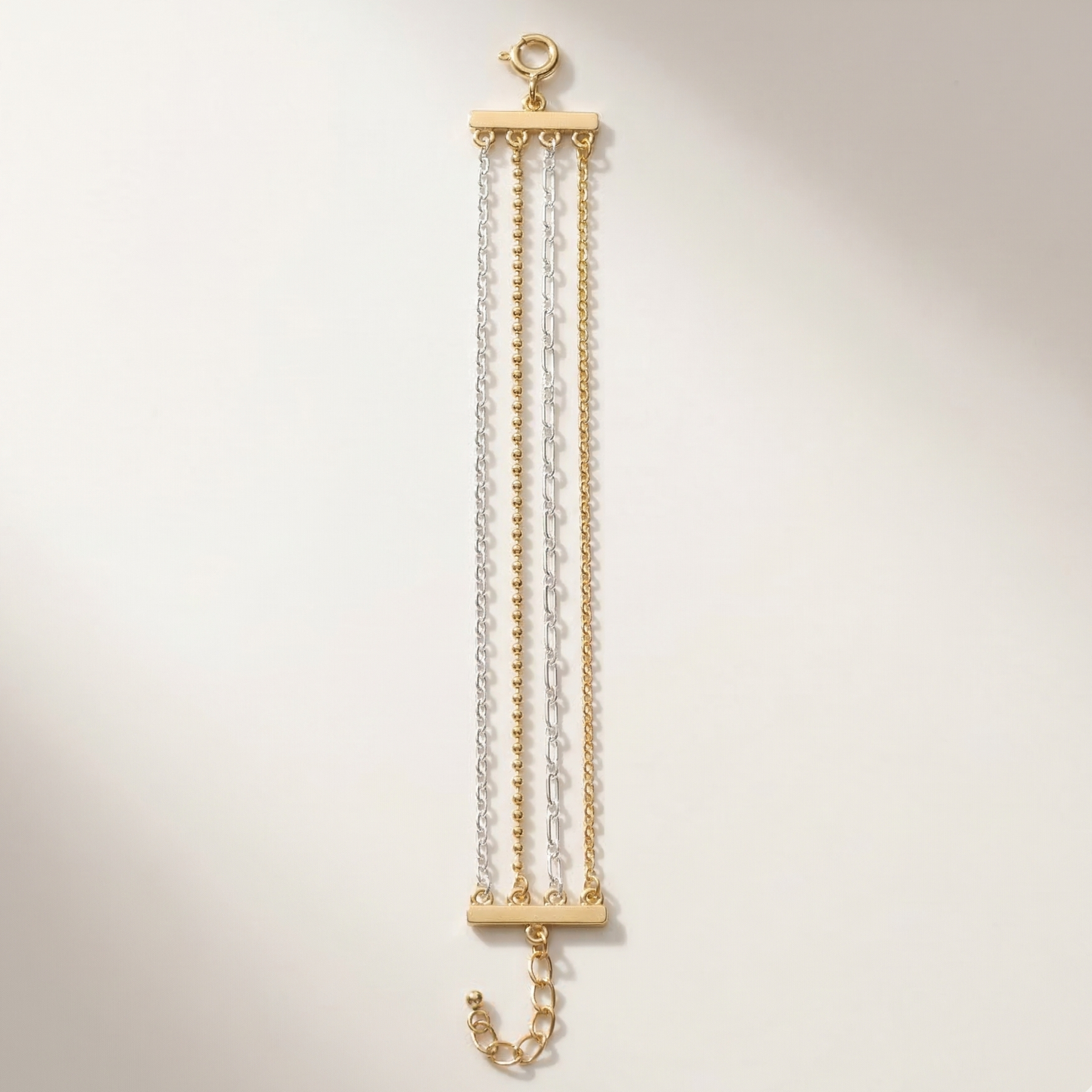 Gold and clear chain necklace on a light beige background