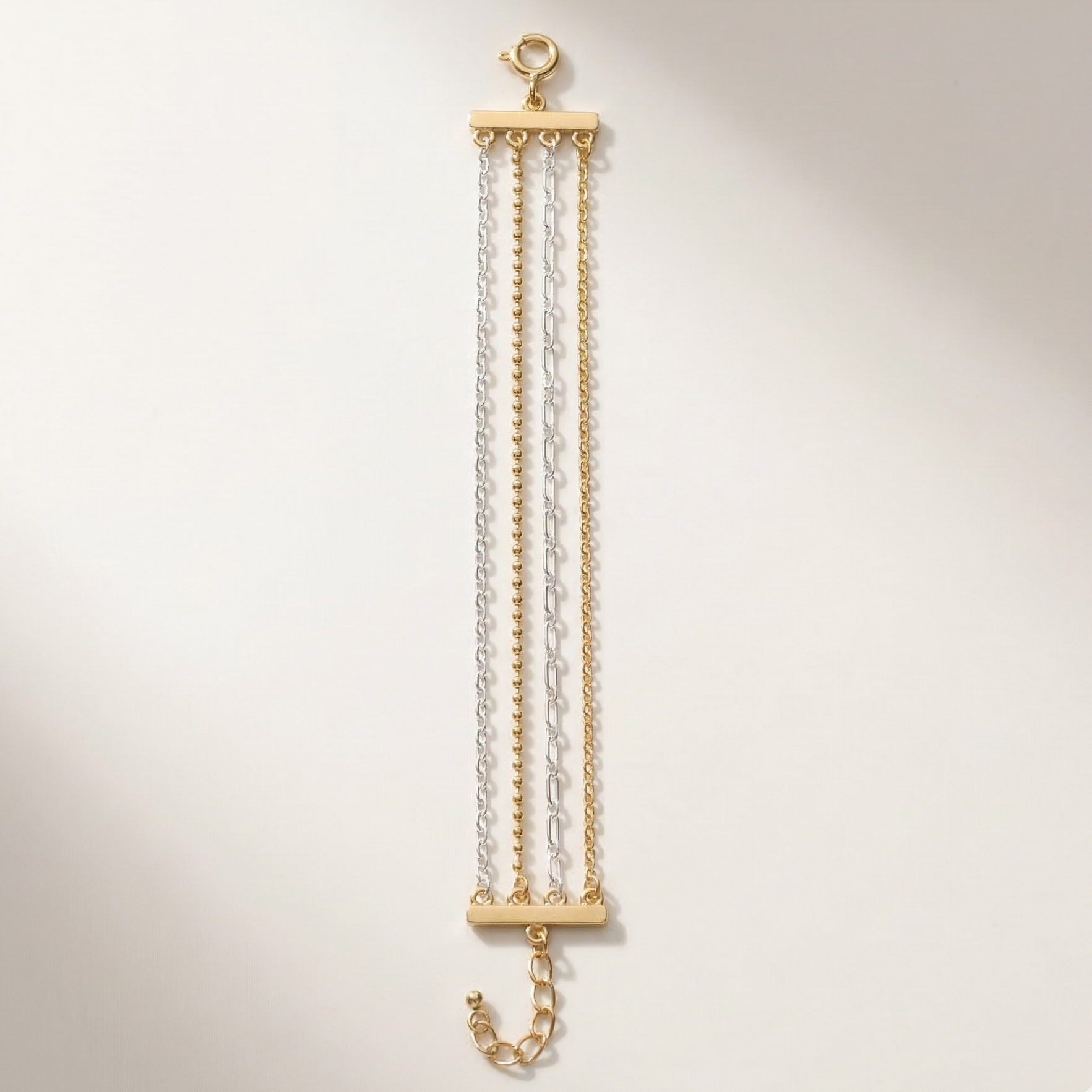 Gold and clear chain necklace on a light beige background