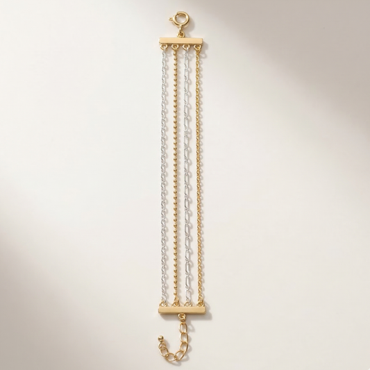 Gold and clear chain necklace on a light beige background