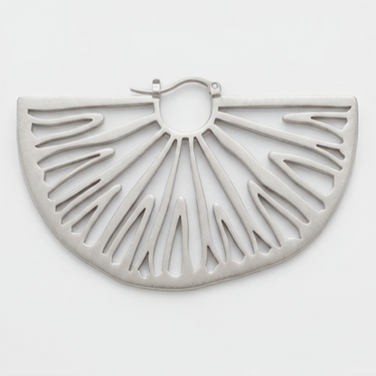 A silver-toned metal semi-circular earring with a cutout sunburst design, displayed on a clean white background.