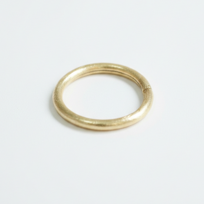 Gold bangle on a white background